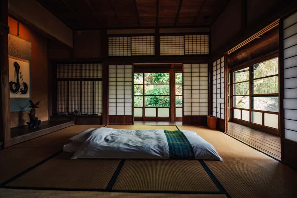 Un futon sur le sol en tatamis d'une maison traditionnelle japonaise
