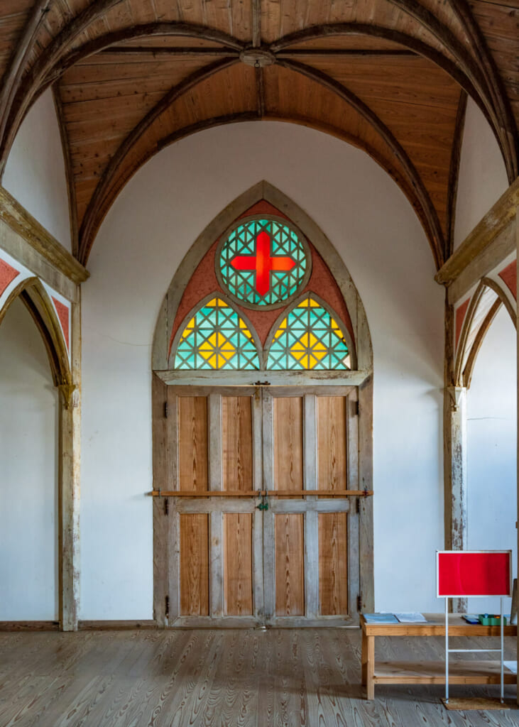 Porte d'entrée de l'église de Gorin surmontée d'un vitrail coloré