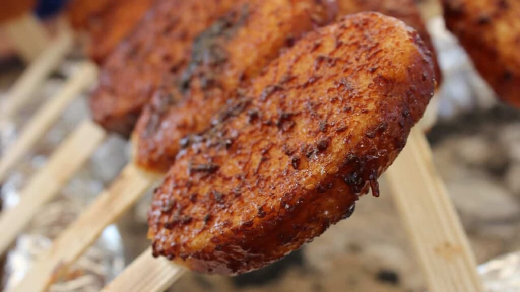 gohei mochi - brochettes de mochi enrobées de sauce soja sucrée et cuites au four