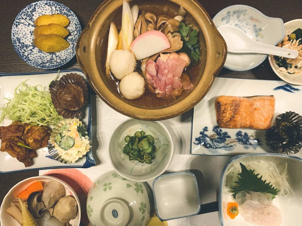 Un nabe japonais accompagné d'une multitude de plats lors dun séjour dans une ferme de Semboku