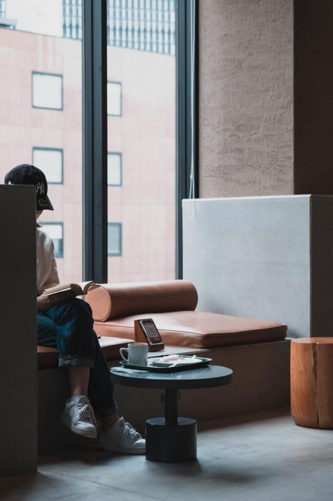 Japonaise en train de lire un livre dans un café à Tokyo