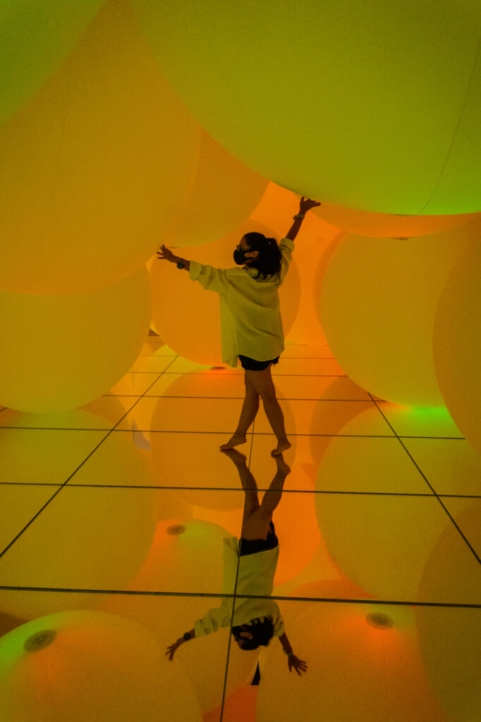 esferas de luz de color amarillo - teamLab Planets