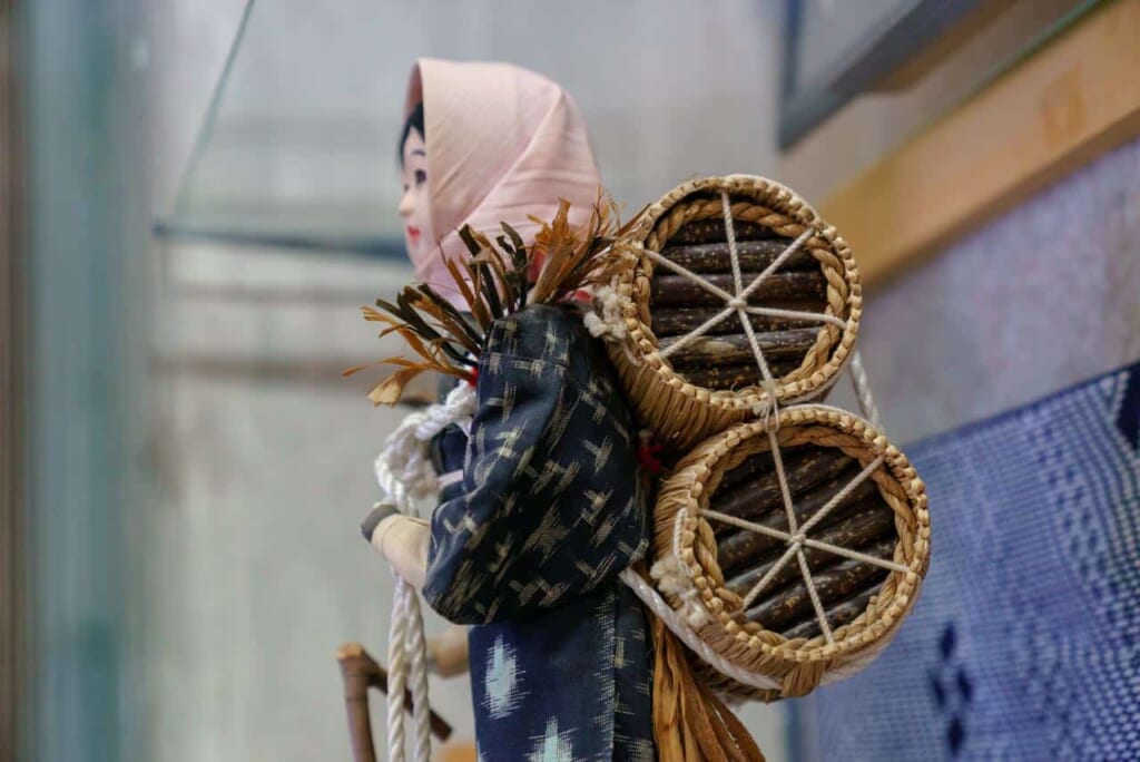 Una figura de una mujer cargando carbón